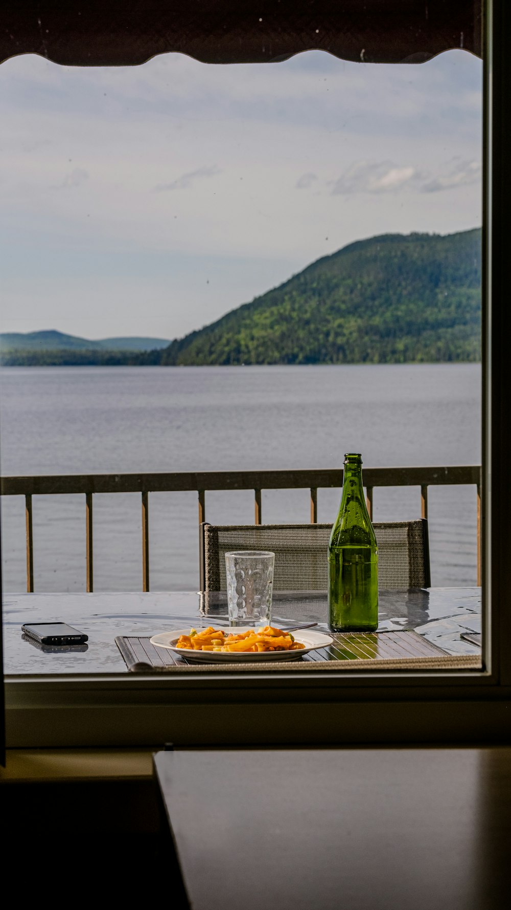 green glass bottle on brown wooden table