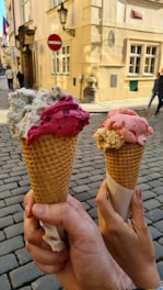 Close-up of two colorful ice cream cones side by side on a sunny day.