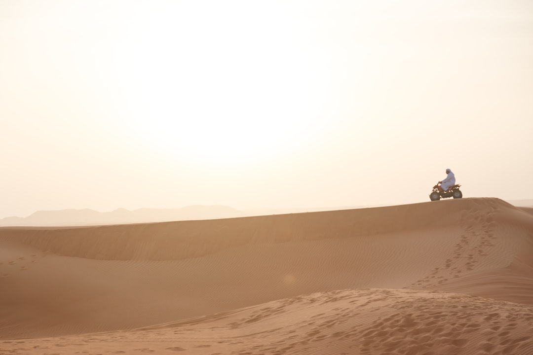 person walking on desert during daytime