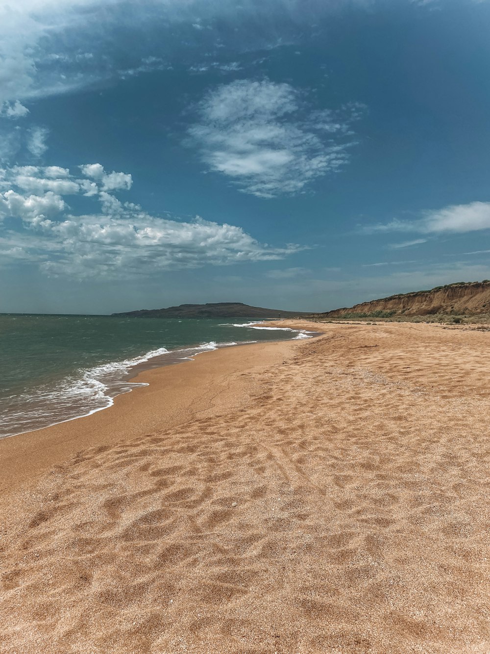 blue sea under blue sky and white clouds during daytime