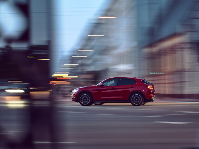red 5 door hatchback on road during daytime