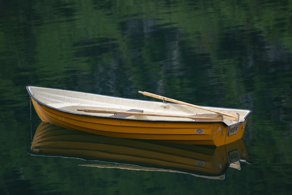 brown and white boat on lake during daytime