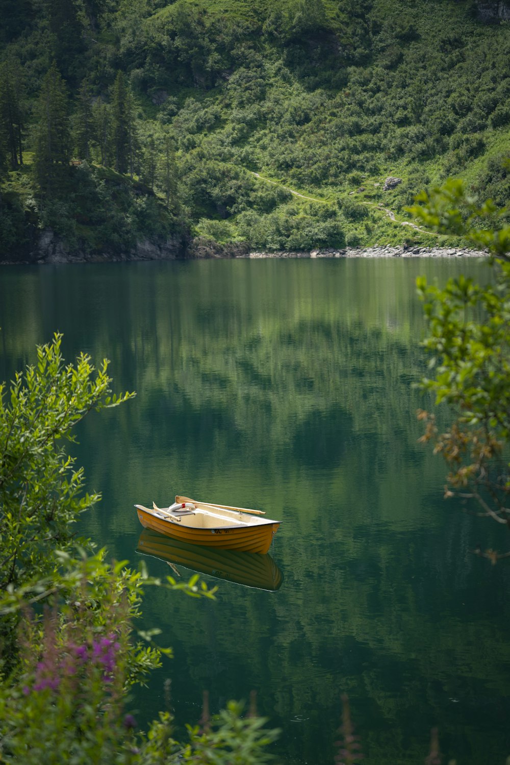 brown wooden boat on lake during daytime