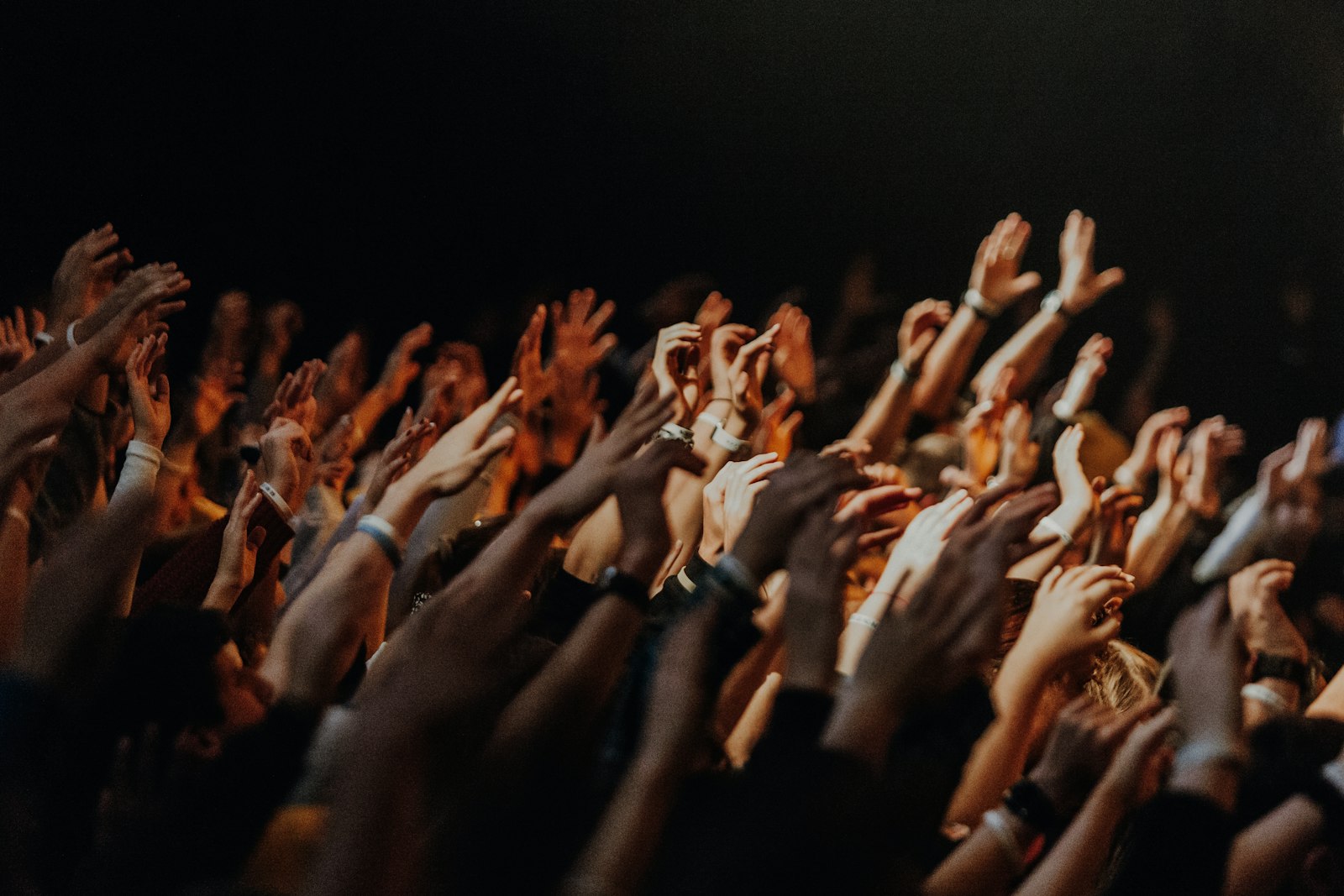 Young people raising their hands in worship and praise