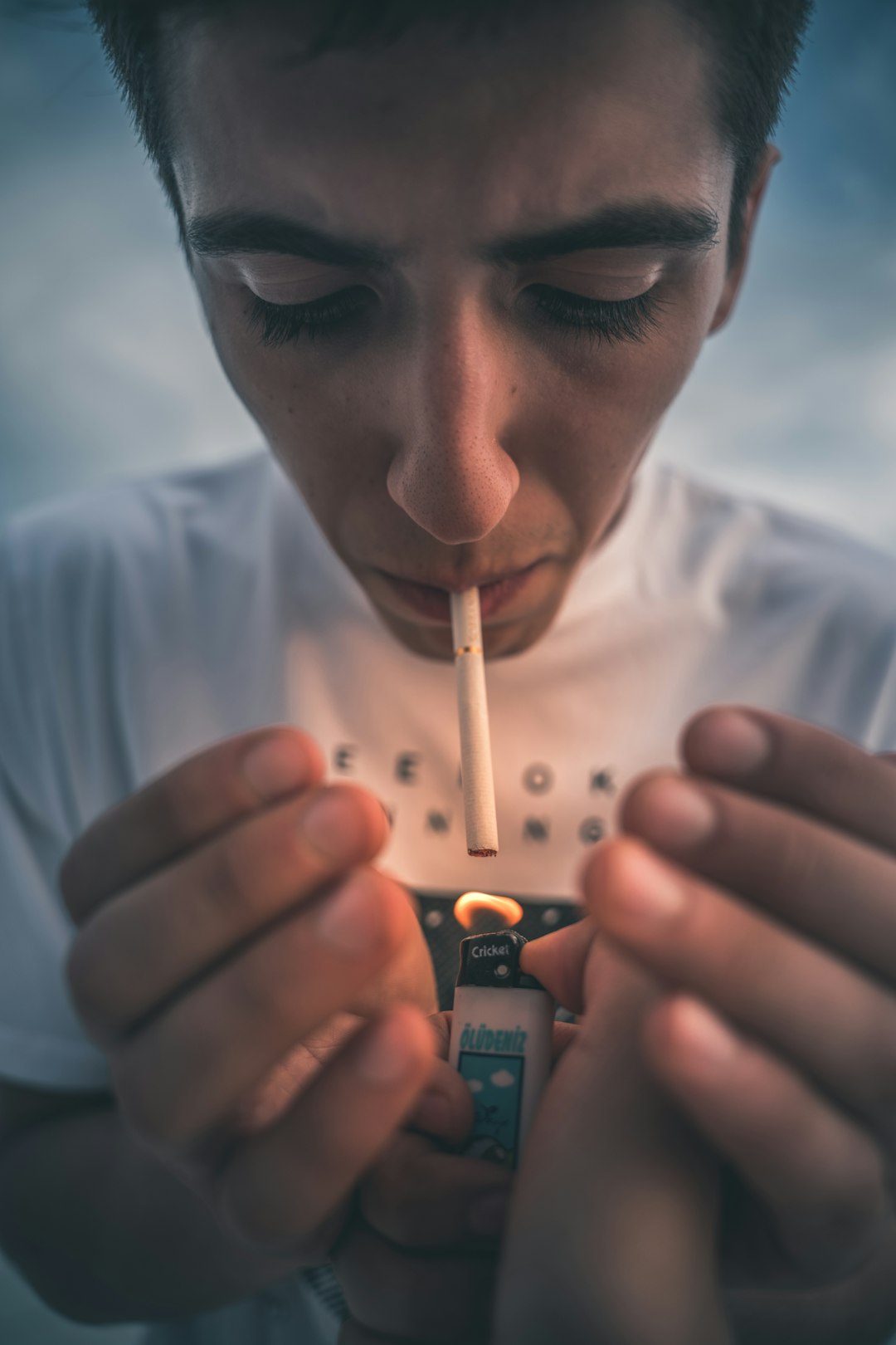 man in white crew neck shirt smoking