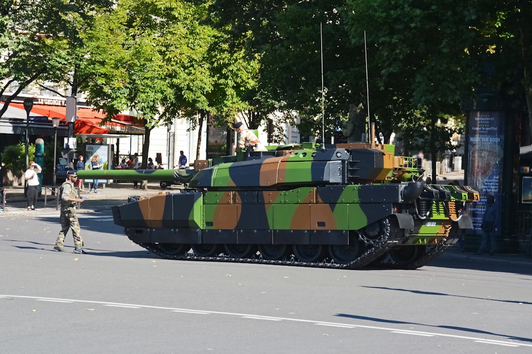 green and brown battle tank on road during daytime