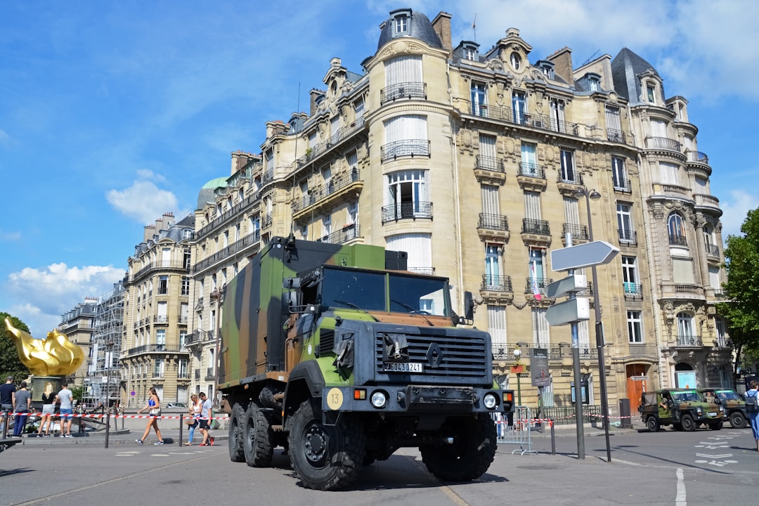 green and black truck on road near building during daytime