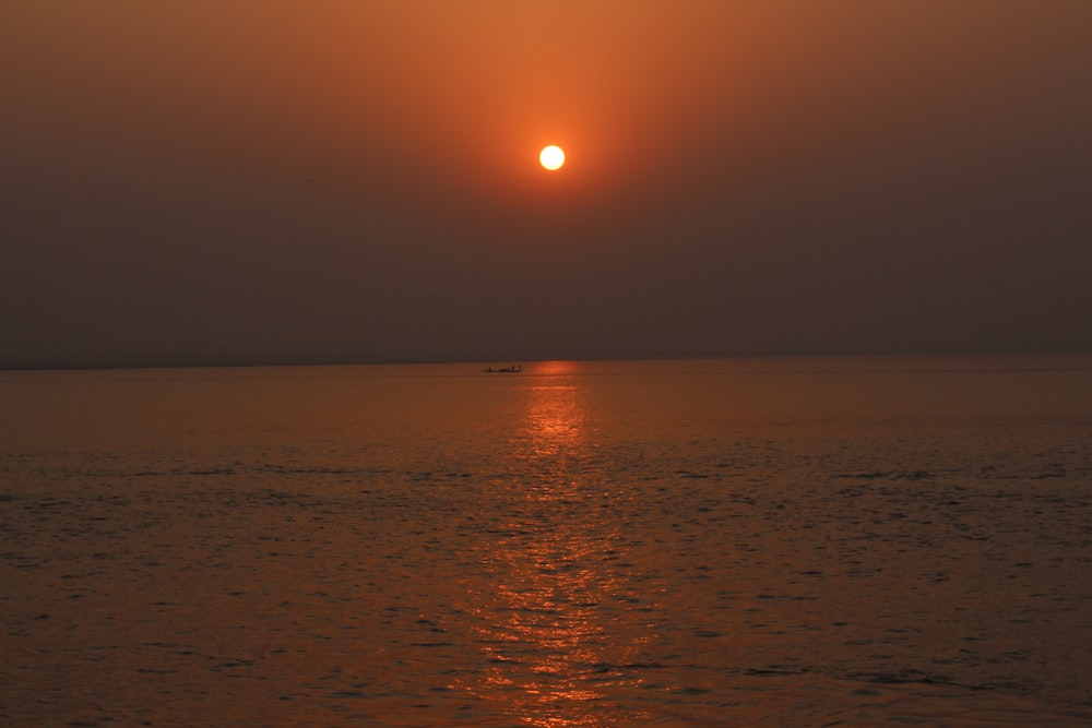 body of water during sunset