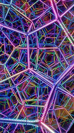 An artful arrangement of LED strips creating a glowing geometric pattern with subtle sparkling overlays.