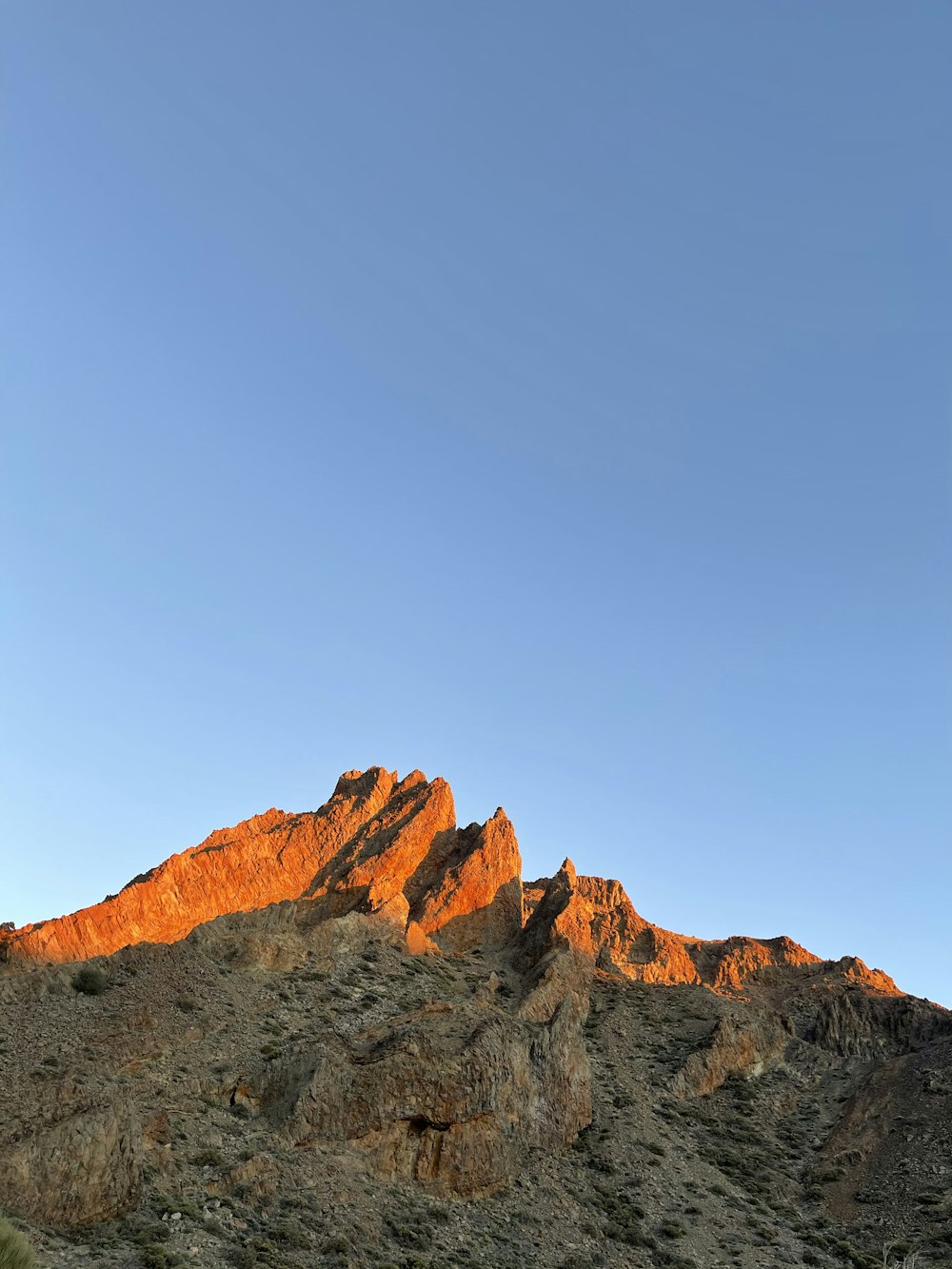 brown rocky mountain under blue sky during daytime