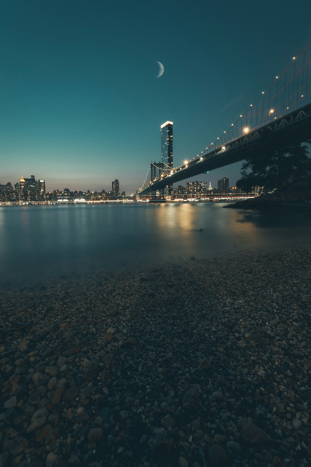 body of water near bridge during night time