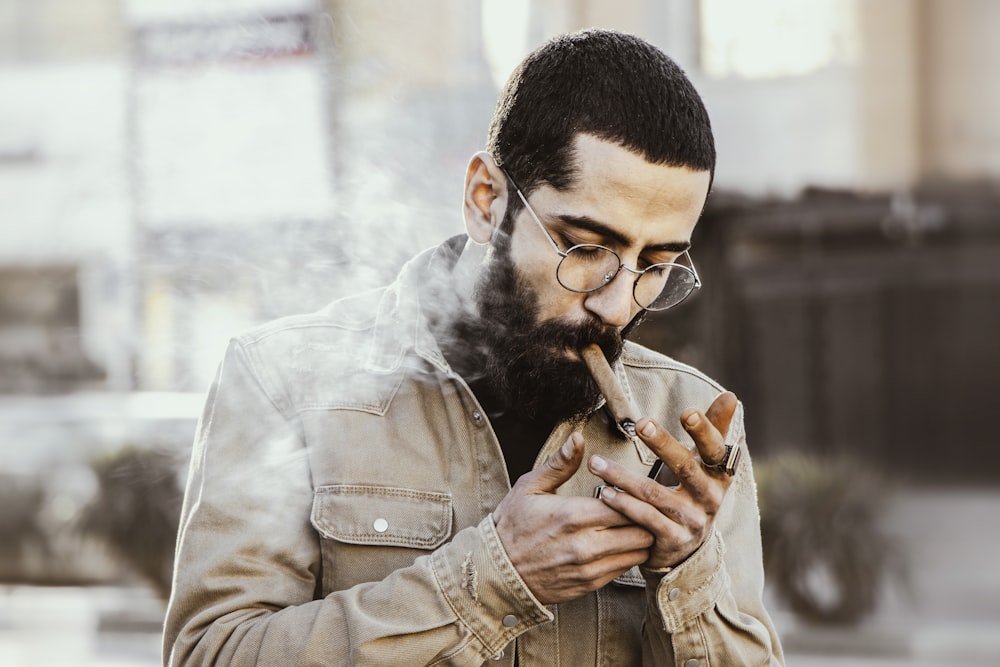 man in brown jacket smoking cigarette