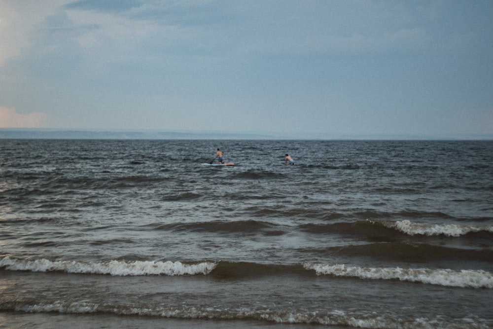 person surfing on sea waves during daytime