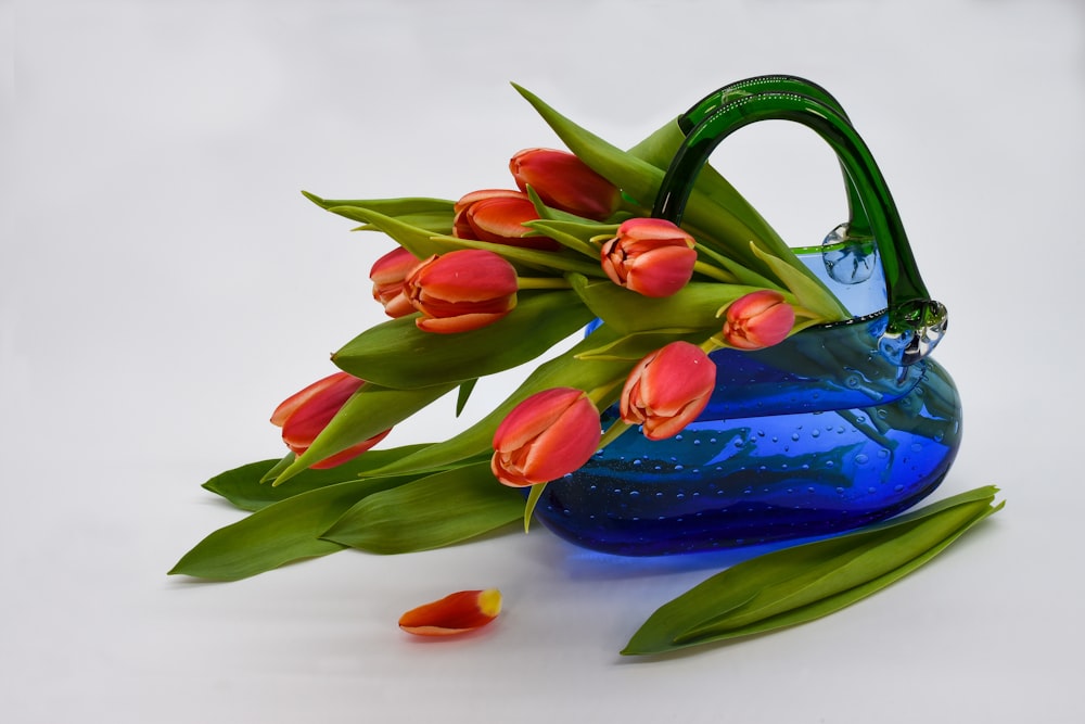red and blue flower on blue ceramic vase