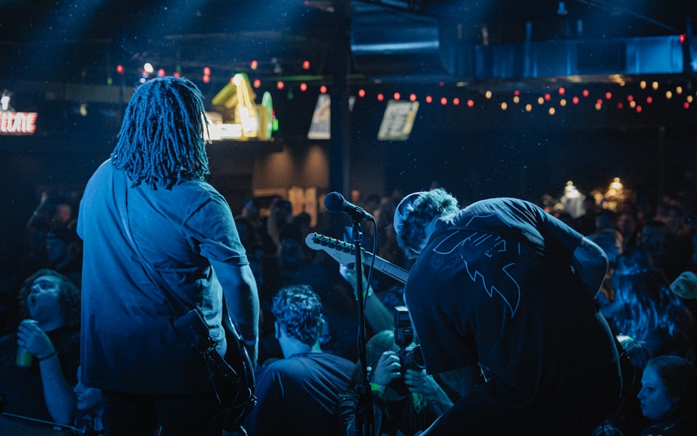 a group of people that are standing in front of a microphone