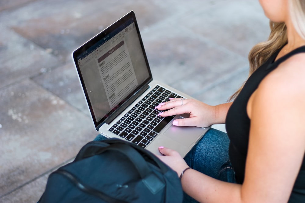 person in green shirt using macbook air