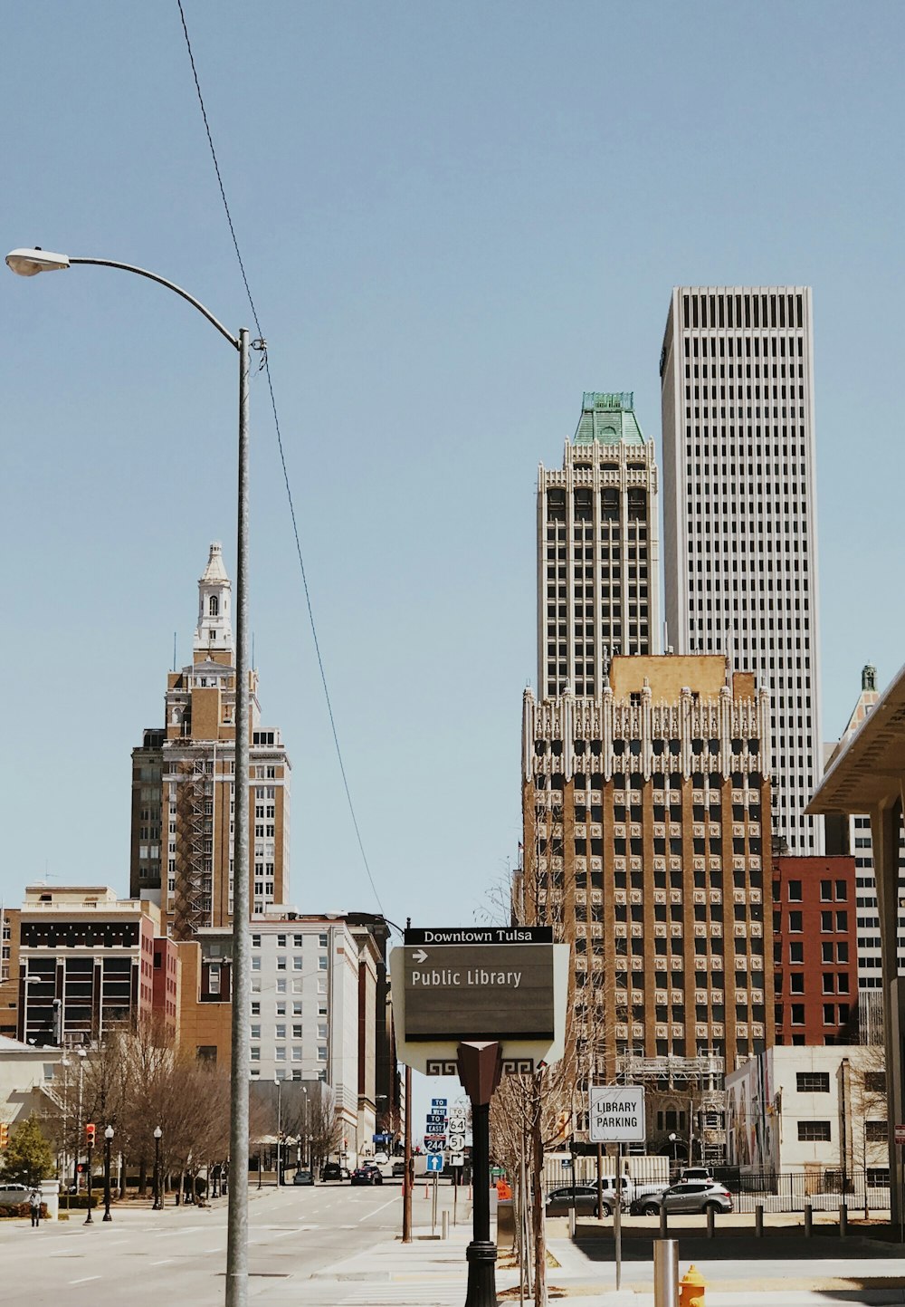 a city street with tall buildings in the background