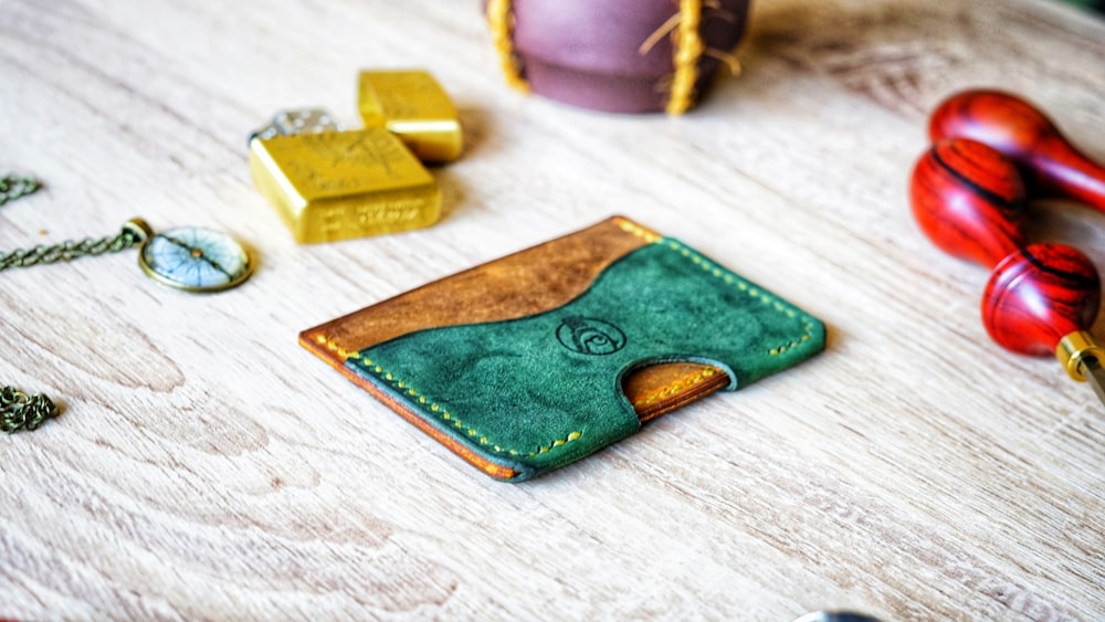 green and brown leather pouch