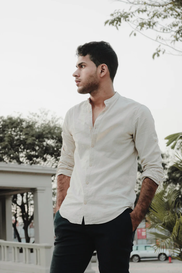 Man in an off-white band collar linen shirt outdoors