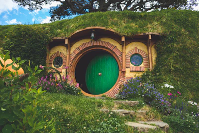 green and brown tunnel surrounded by green trees during daytime