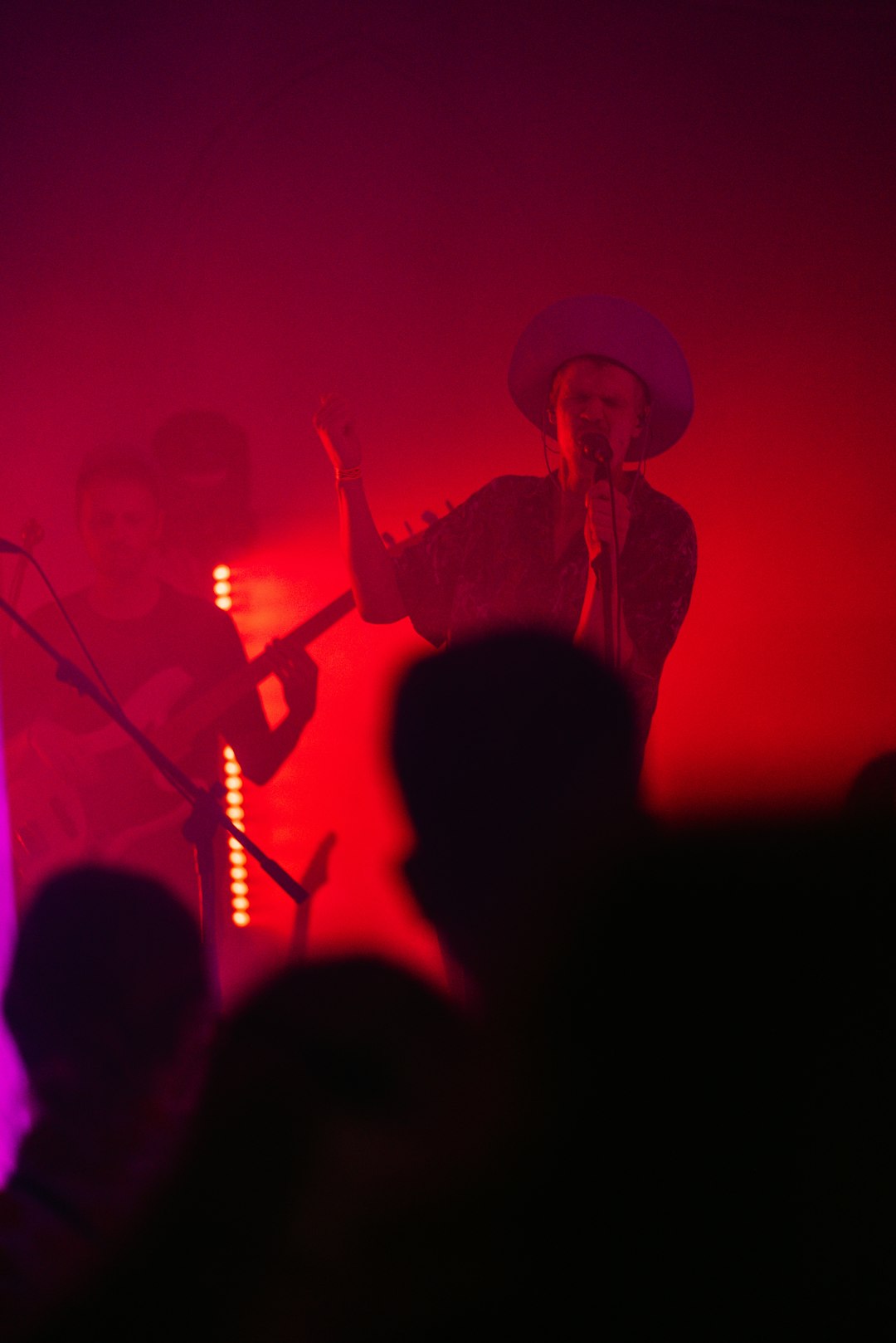 man in brown cowboy hat singing