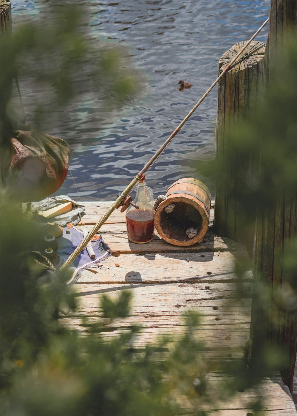 brown wooden fishing rod on brown wooden dock