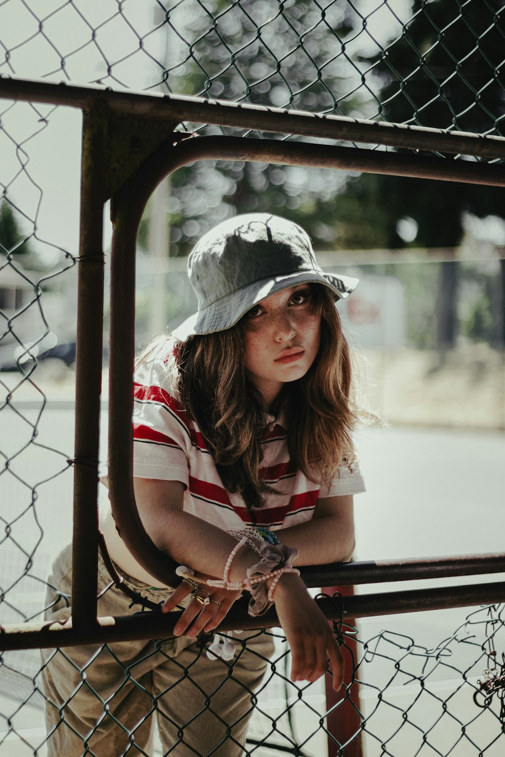 woman in red and white plaid shirt wearing gray hat