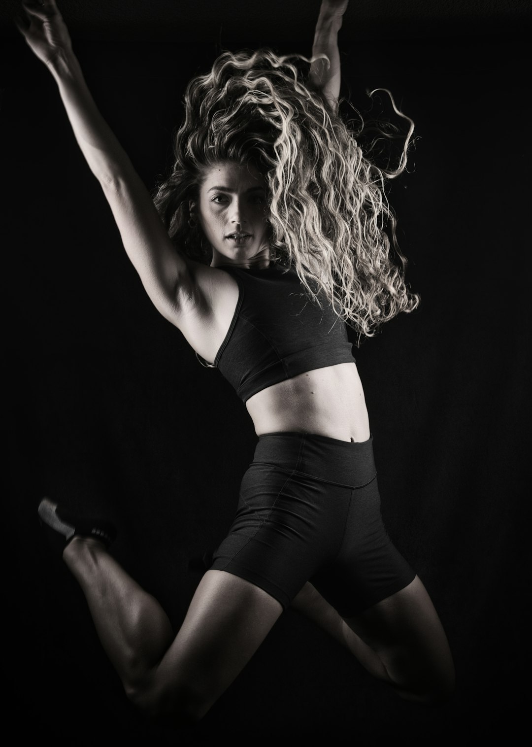 woman in black sports bra and black shorts