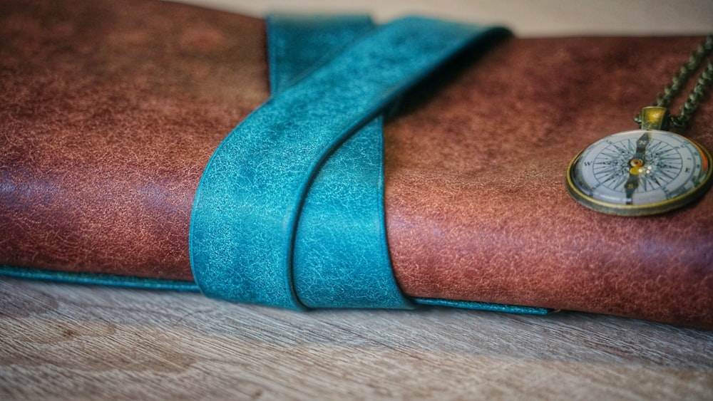 brown and teal textile on brown wooden table
