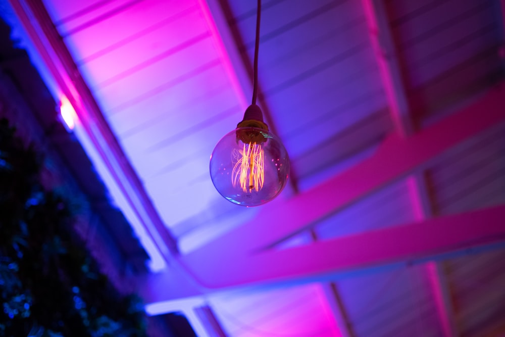 silver pendant lamp turned on in room