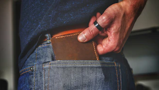 person holding black and brown leather bag