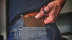 person holding black and brown leather bag