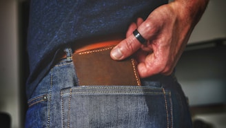 person holding black and brown leather bag