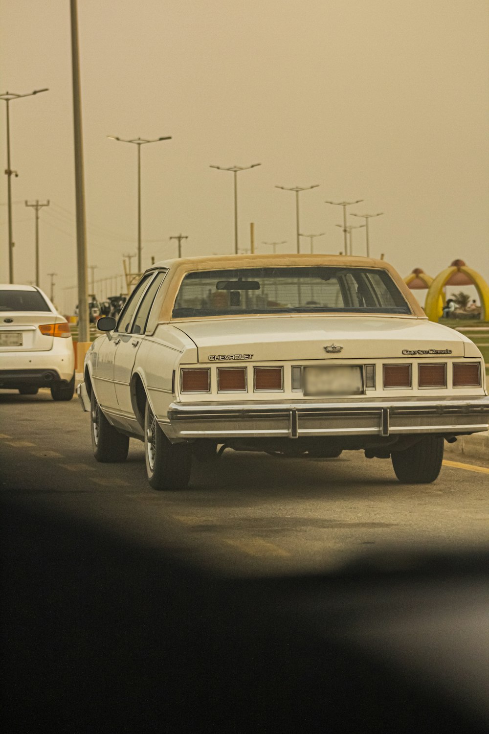 white sedan on road during daytime