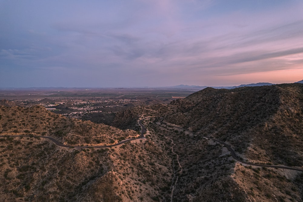 brown and gray mountains under white clouds during daytime