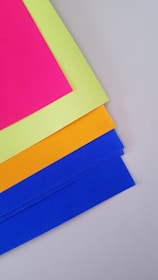 Close-up of colorful educational materials and worksheets laid out on a warm pastel background.