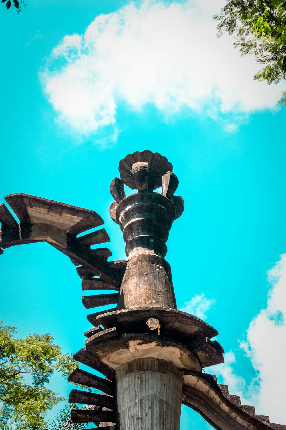 brown concrete statue under blue sky during daytime