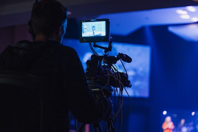 A man standing in front of a camera on a stage