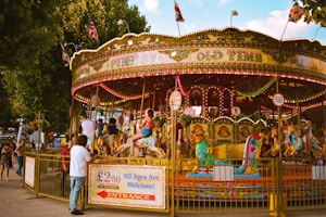 people riding on carousel during daytime