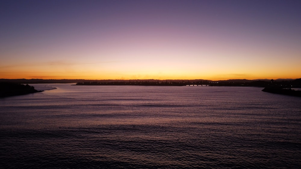 body of water during sunset