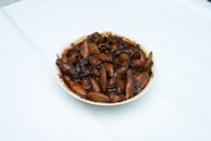 Close-up of a vibrant alubias con chipirón en su tinta, highlighting the rich black sauce.