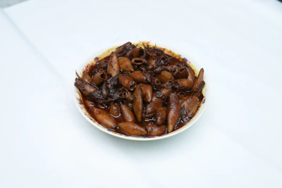 Close-up of pimientos rellenos de calamar, vibrant and inviting on a white plate.