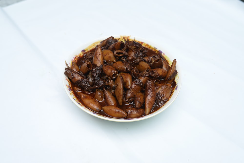 brown food on white ceramic bowl