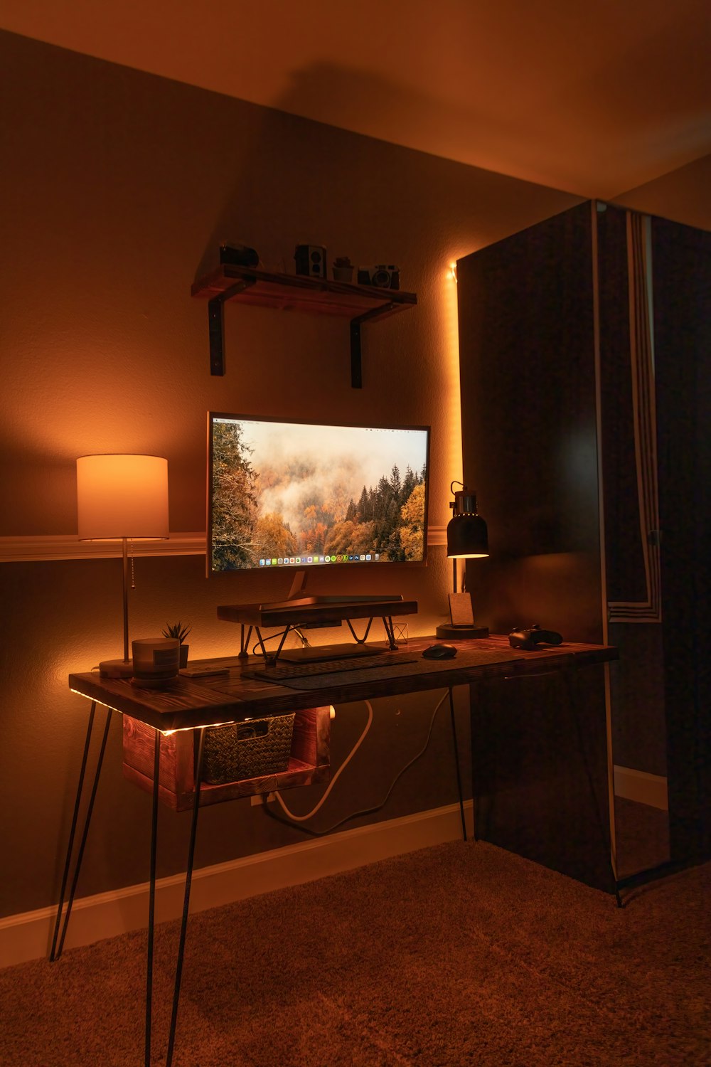 black flat screen computer monitor on brown wooden desk