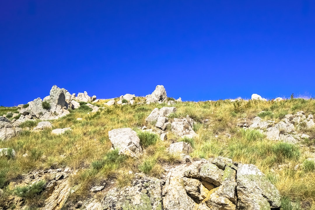 gray rocky mountain under blue sky during daytime