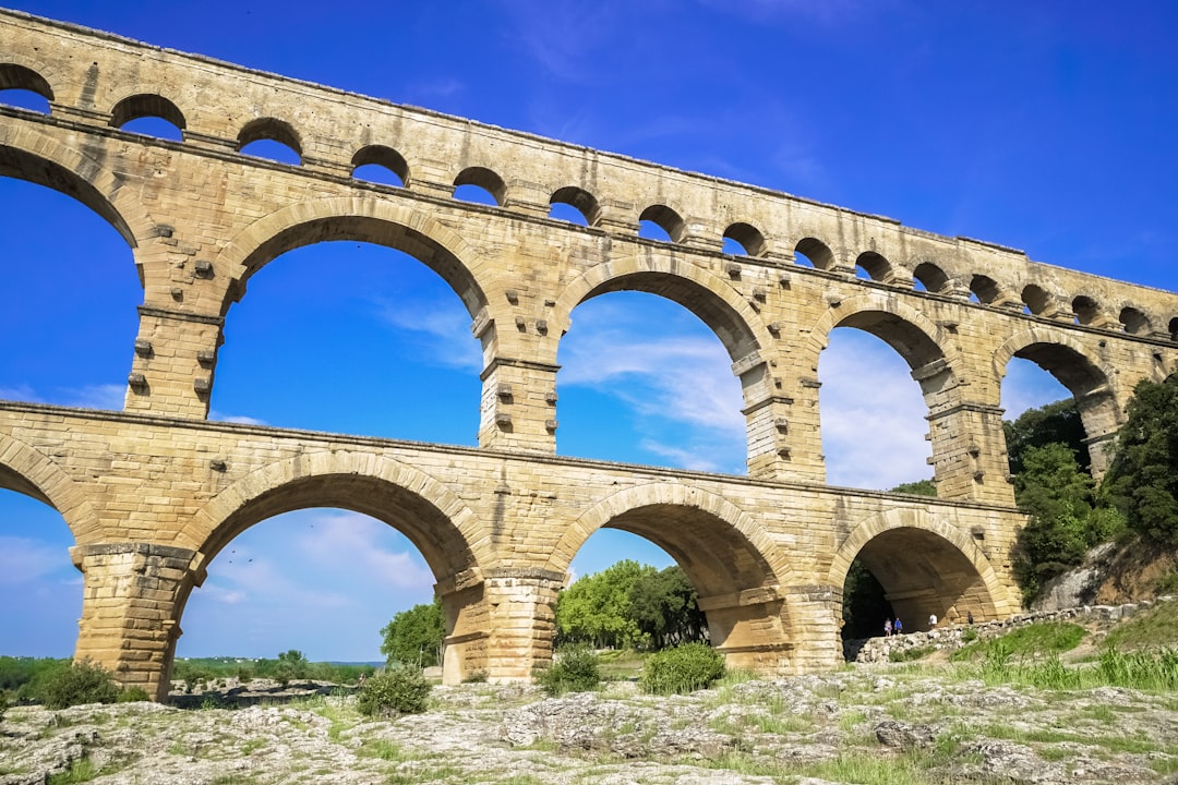 brown concrete bridge under blue sky during daytime