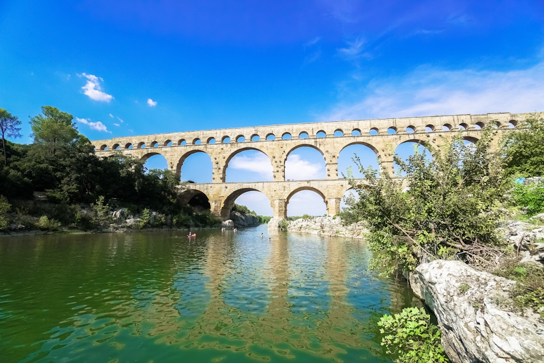 white concrete bridge over river under blue sky during daytime