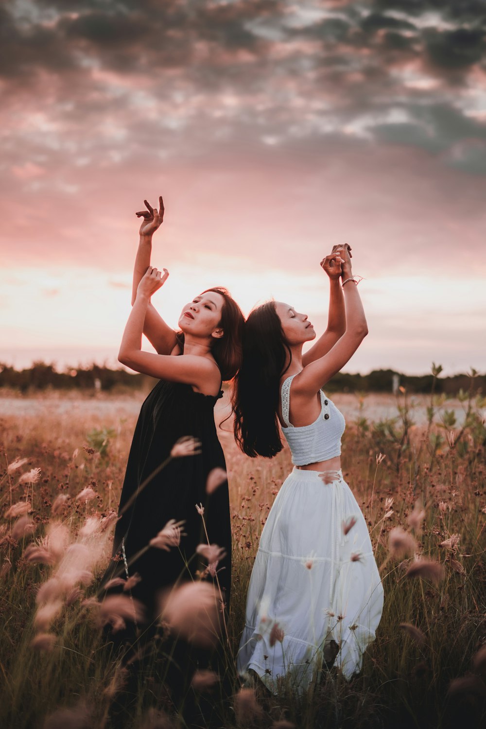 2 women in white dress standing on brown grass field during daytime