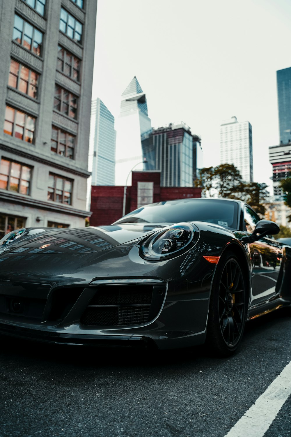 black porsche 911 parked near white concrete building during daytime