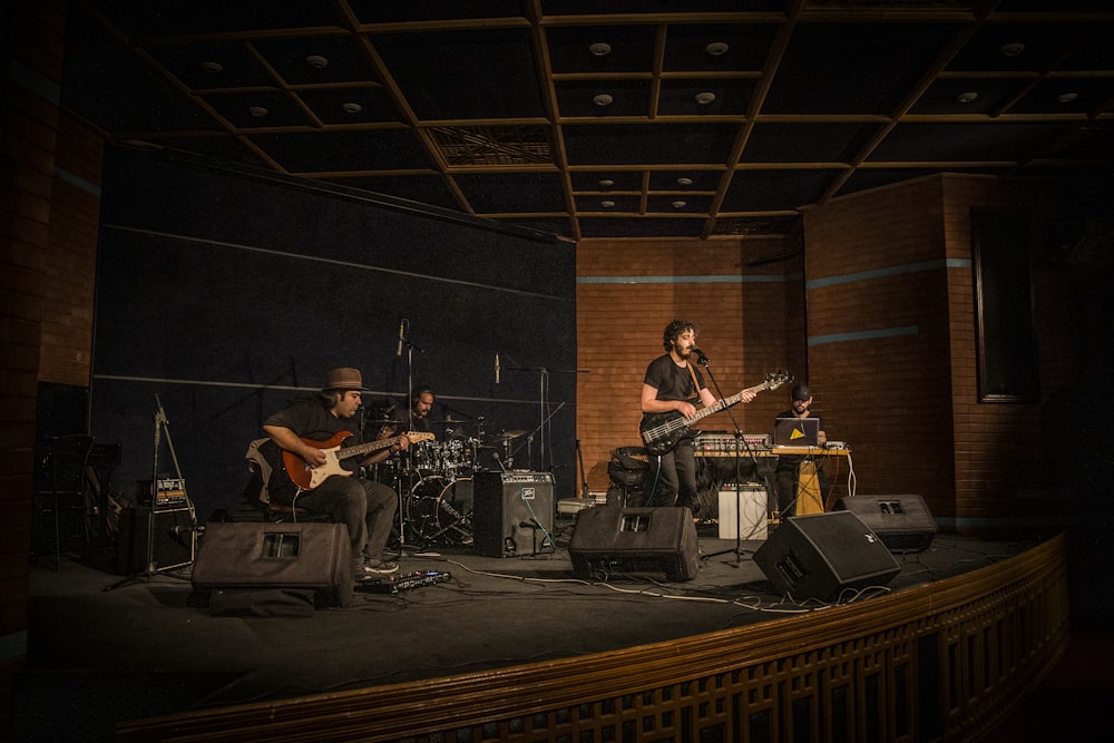 man in black shirt playing guitar on stage